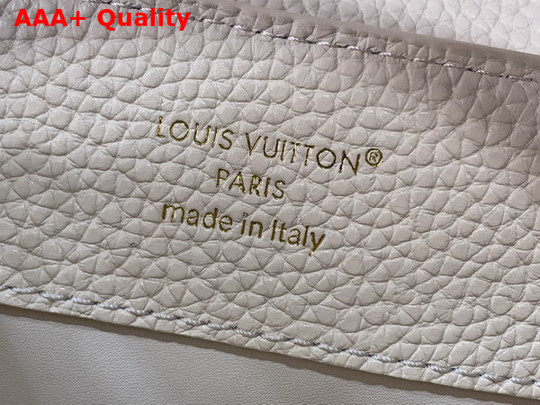 Louis Vuitton Capucines BB Handbag in Vanilla Taurillon Leather Embellished with Tonal LV Initials and a Decorative Stone Embellished Charm Replica