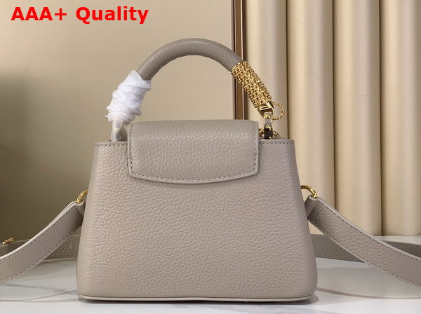 Louis Vuitton Capucines Mini Handbag in Galet Gray Taurillon Leather Embellished with Tonal LV Initials and a Decorative Stone Embellished Charm Replica