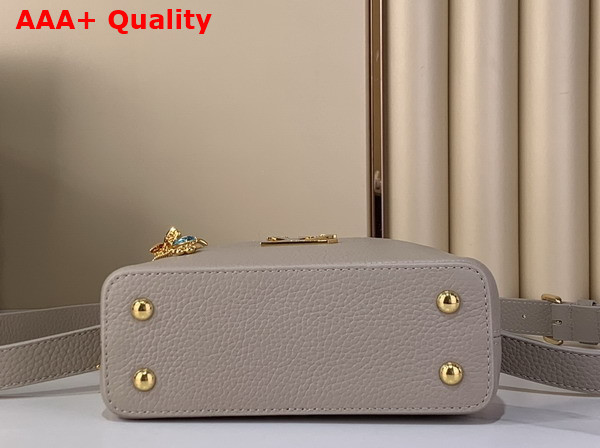 Louis Vuitton Capucines Mini Handbag in Galet Gray Taurillon Leather Embellished with Tonal LV Initials and a Decorative Stone Embellished Charm Replica