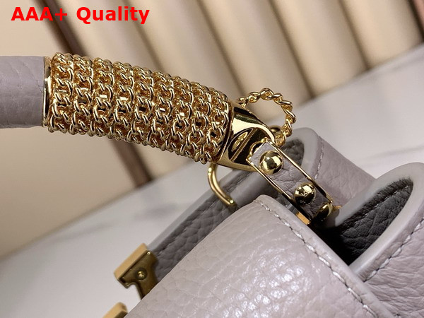 Louis Vuitton Capucines Mini Handbag in Galet Gray Taurillon Leather Embellished with Tonal LV Initials and a Decorative Stone Embellished Charm Replica