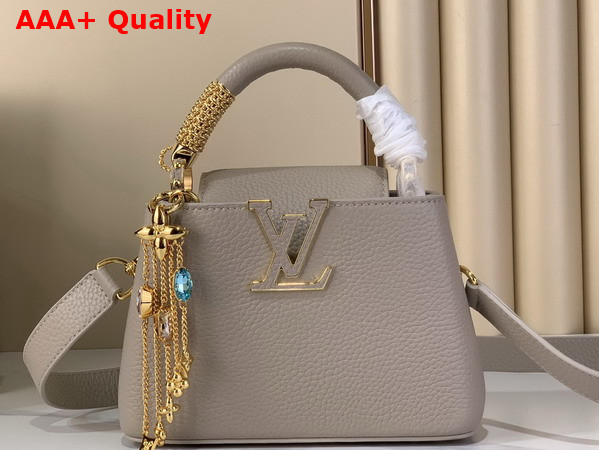 Louis Vuitton Capucines Mini Handbag in Galet Gray Taurillon Leather Embellished with Tonal LV Initials and a Decorative Stone Embellished Charm Replica